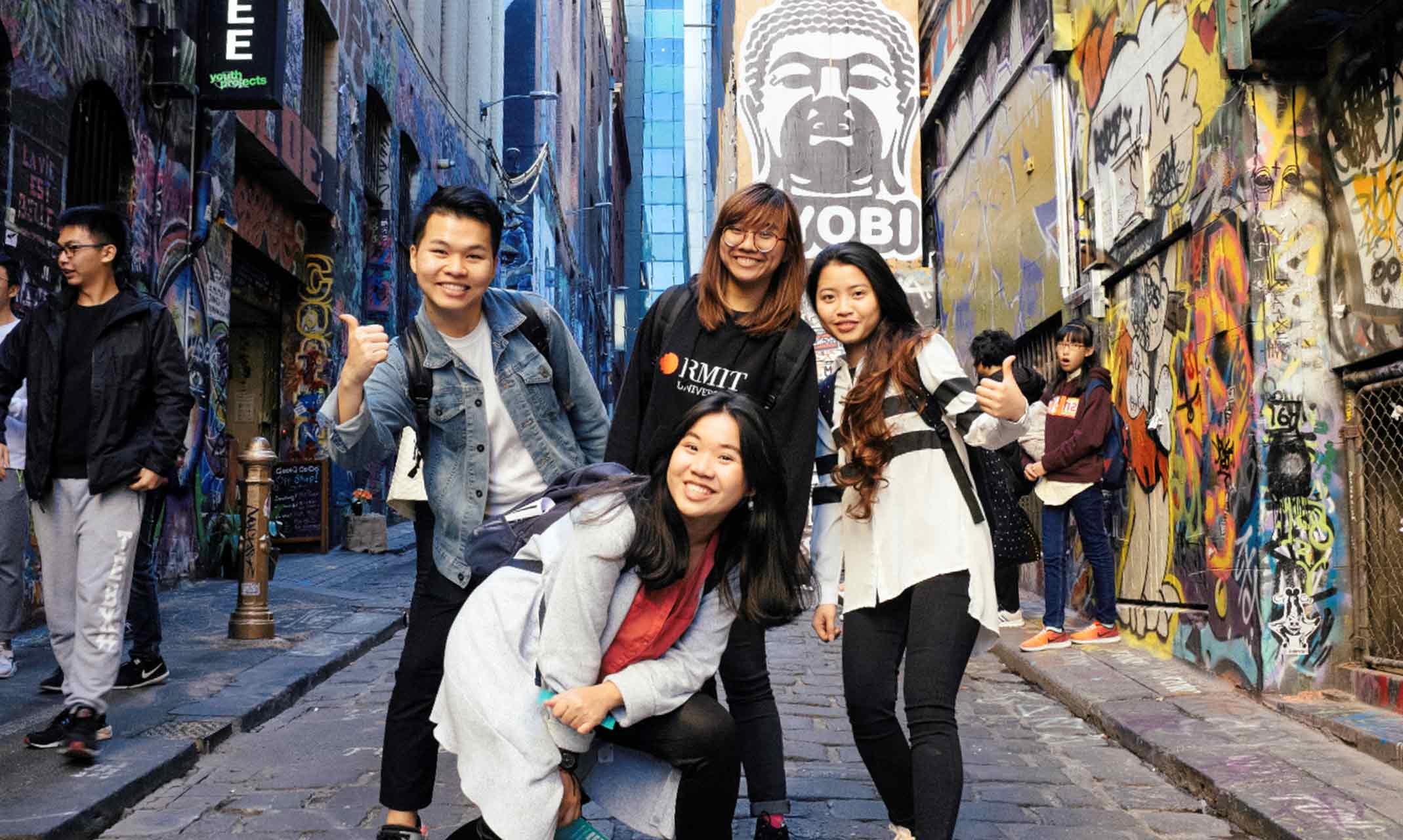 Four students posing in the famous Melbourne Hosier laneway