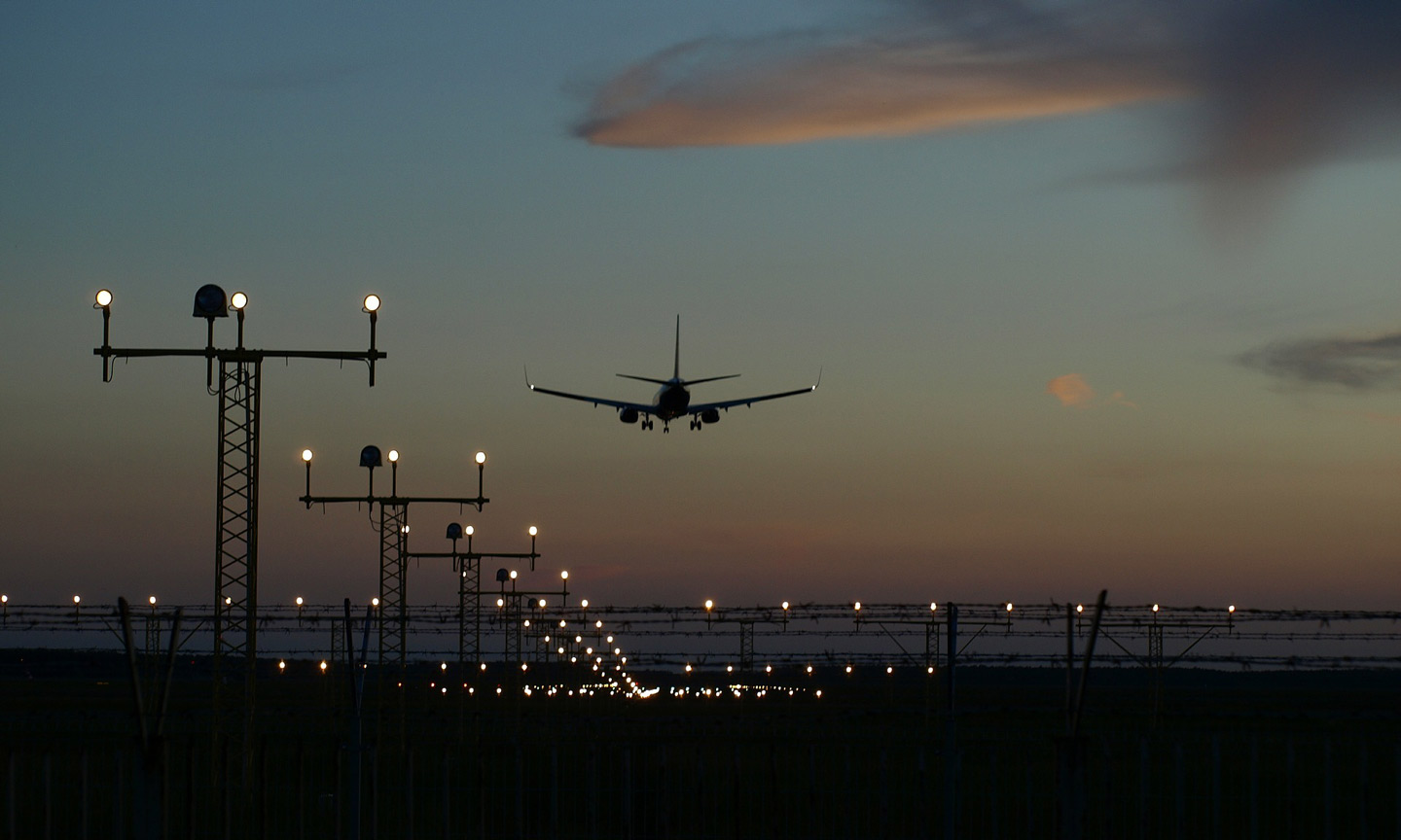 Plane landing at airport at night